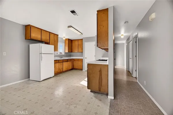 a kitchen with stainless steel appliances a refrigerator and a stove