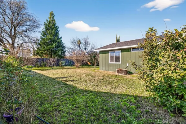 a view of backyard with wooden fence