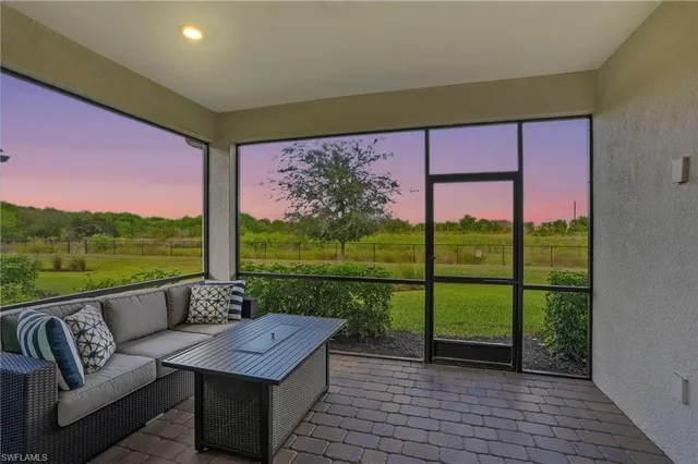 a view of a porch with furniture and a yard