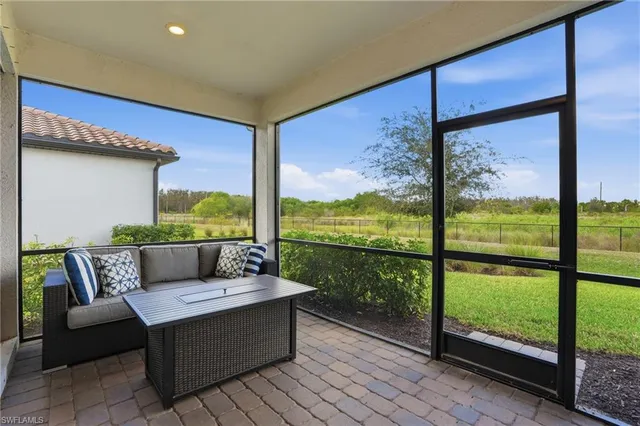 a living room with couch and a floor to ceiling window
