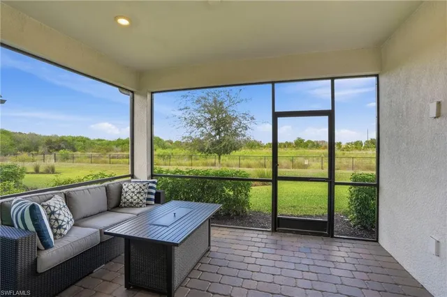 a living room with couch and a floor to ceiling window