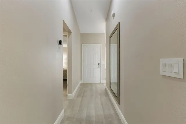 a kitchen with stainless steel appliances a table and chairs