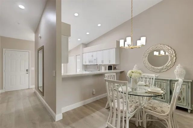 a living room with large trees and a potted plant