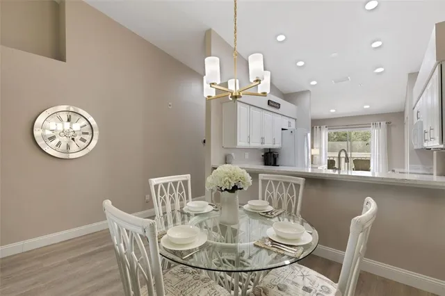 a dining room with furniture and floor to ceiling window