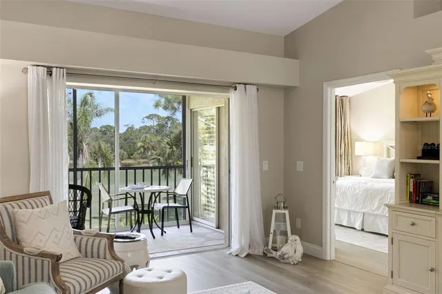 a bedroom with a large bed and a flat tv screen on dresser