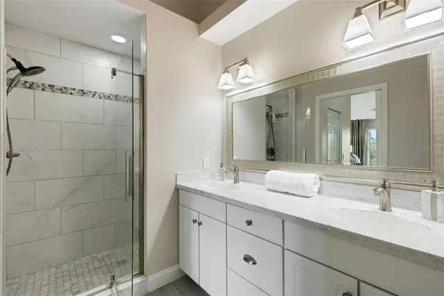 an aerial view of residential house with outdoor space and trees all around