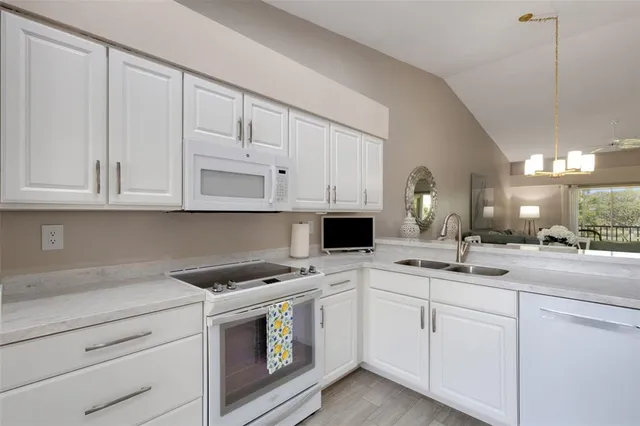 a kitchen with white cabinets and a sink