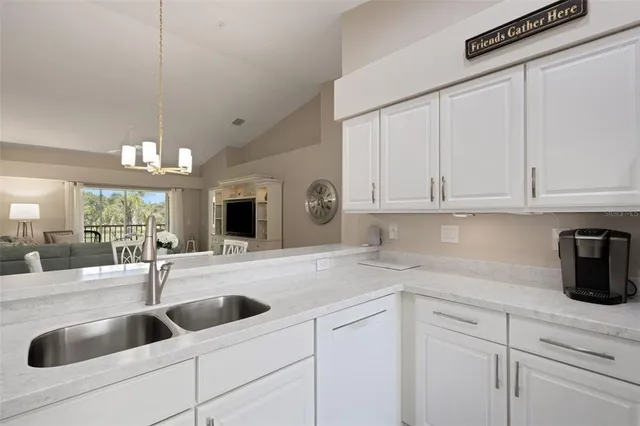 a kitchen with granite countertop a stove a sink and a cabinets