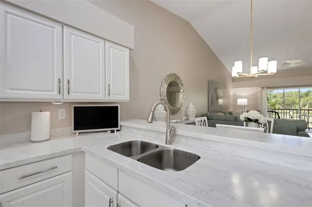 a view of a hallway with wooden floor and a bathroom