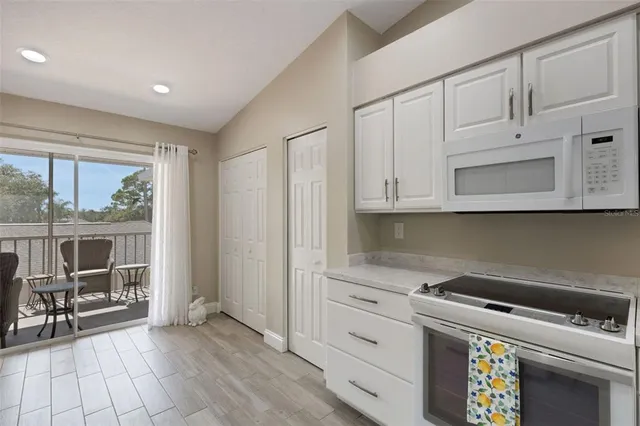 a kitchen with a sink a stove and cabinets