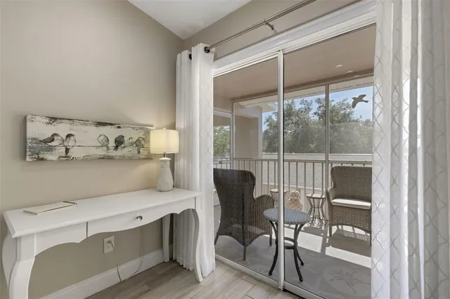 a living room with furniture a fireplace and a large window