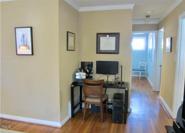 a bedroom with a bed two window and a lamp