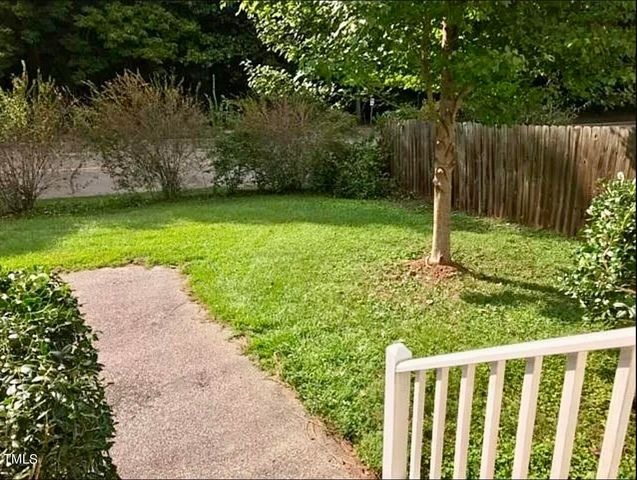 a view of a backyard with large trees