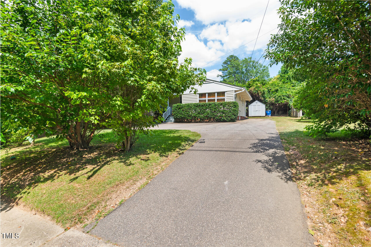 916 Dixie Trail Raleigh, NC 27607 - Photo 19 of 22 a front view of a house with a yard and trees