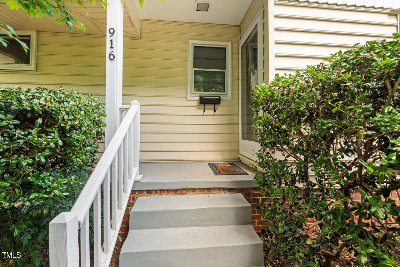 916 Dixie Trail Raleigh, NC 27607 - Photo 2 of 22 a view of a pathway of the house and front of a house