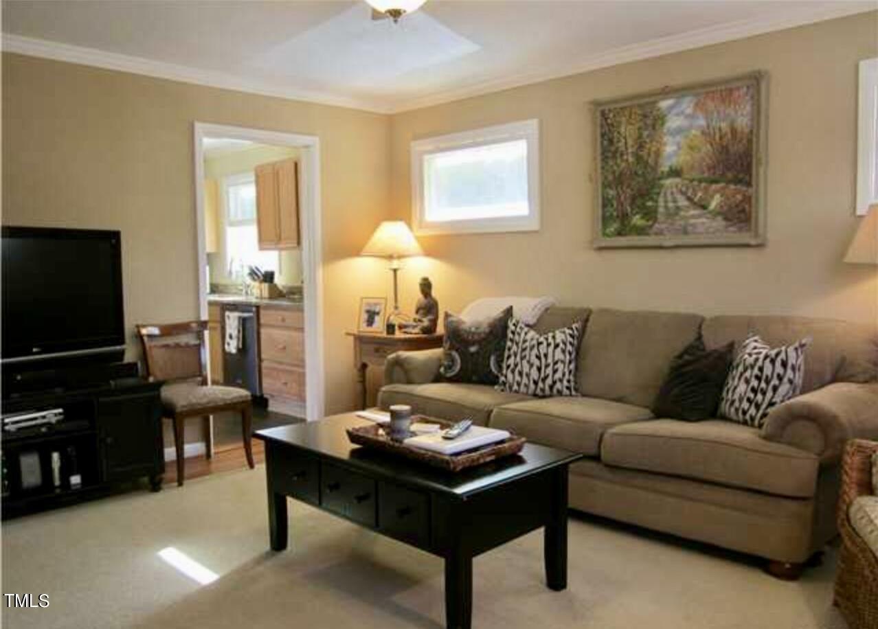 916 Dixie Trail Raleigh, NC 27607 - Photo 6 of 22 a living room with furniture a flat screen tv and a window