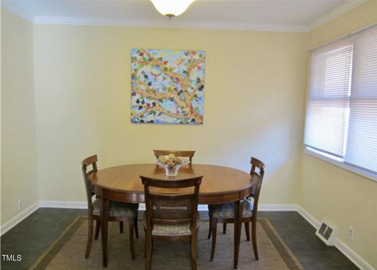 916 Dixie Trail Raleigh, NC 27607 - Photo 7 of 22 a view of a dining room with furniture and wooden floor