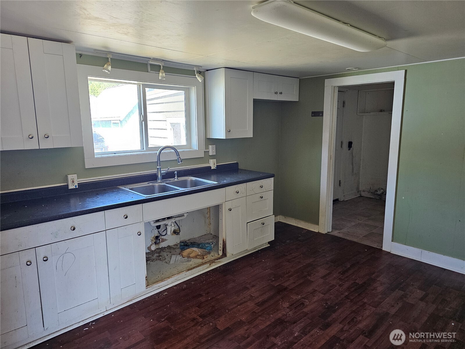 709 Monroe Street Hoquiam, WA 98550 - Photo 6 of 22 a kitchen with a sink cabinets and wooden floor