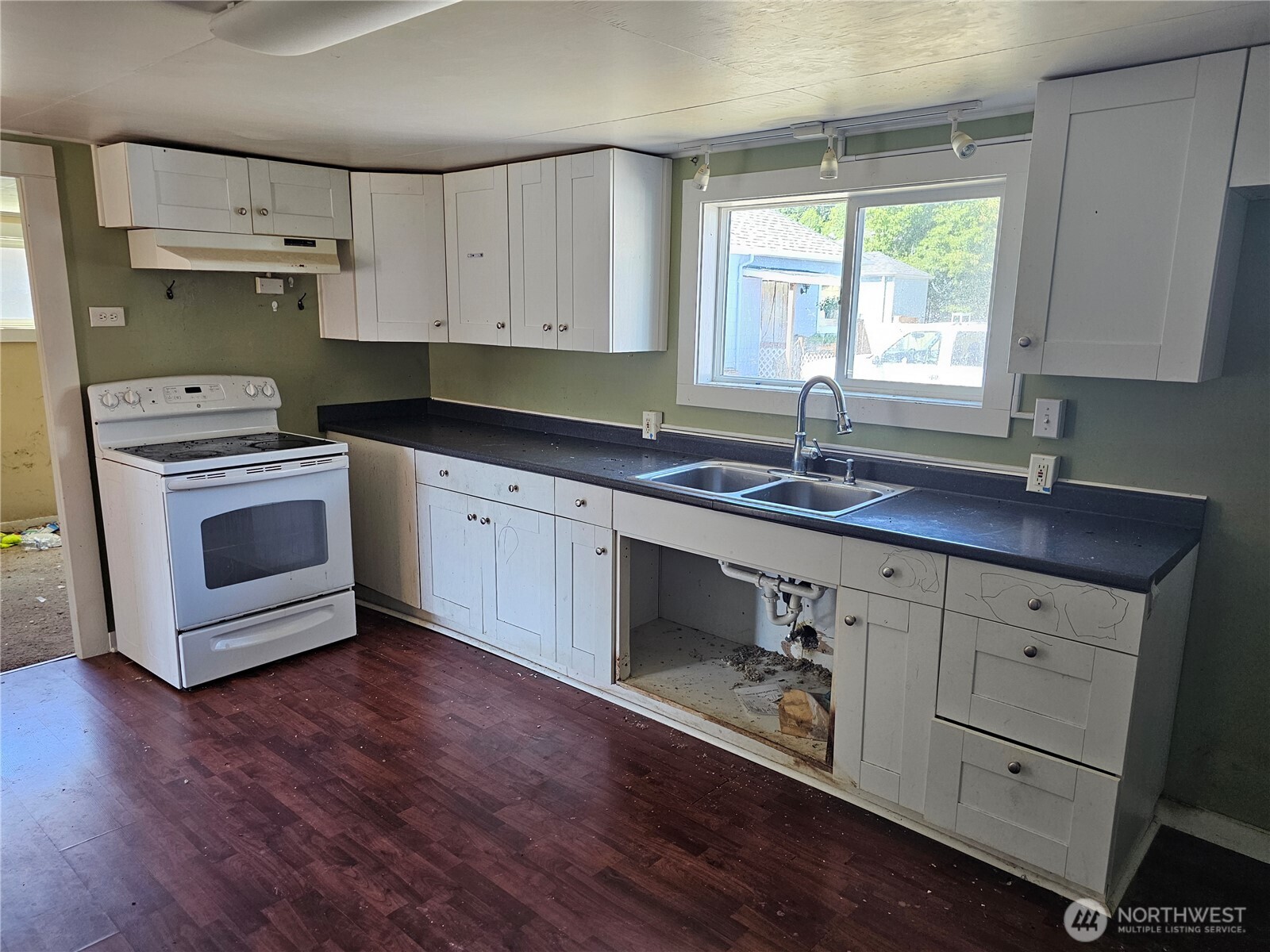 709 Monroe Street Hoquiam, WA 98550 - Photo 7 of 22 a kitchen with sink cabinets and window