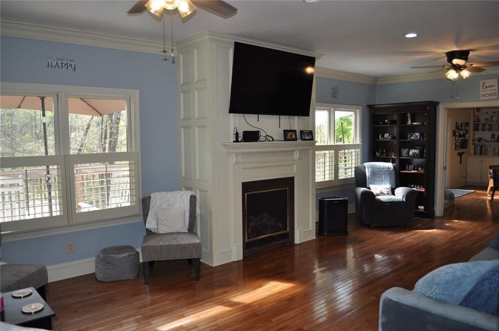 731 Hidden Lakes Trail Jefferson, GA 30549 - Photo 13 of 70 a living room with furniture a flat screen tv and a fireplace