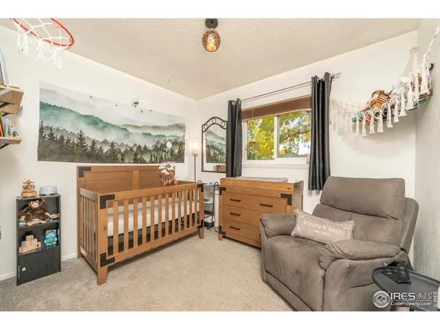 a bedroom with furniture and a baby crib