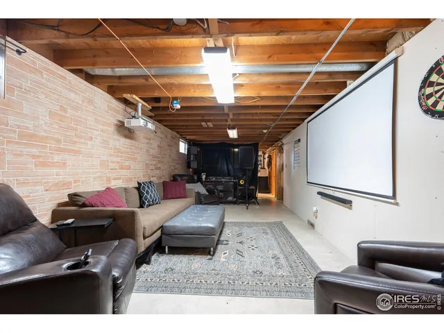a living room with furniture a couch and a ceiling fan