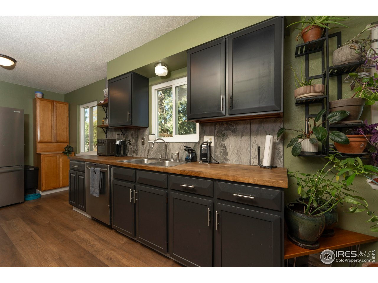 1101 20th Street Southwest Loveland, CO 80537 - Photo 2 of 24 a kitchen with stainless steel appliances granite countertop a sink a stove and a refrigerator