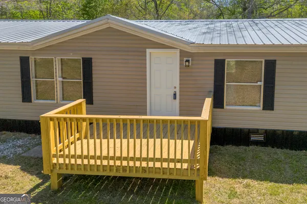 a view of a house with wooden deck