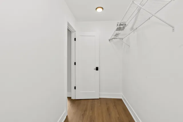 a view of room with wooden floor