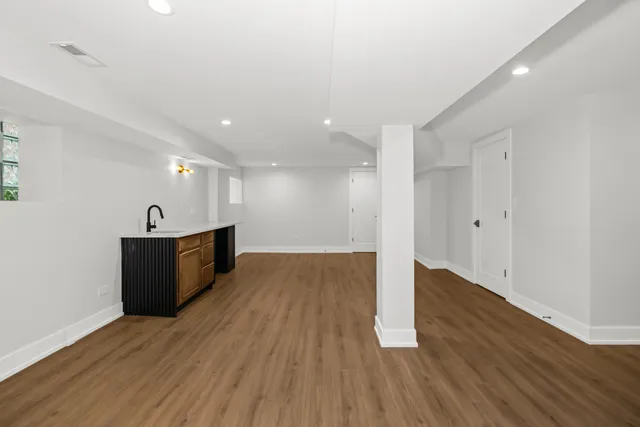 a view of a room with wooden floor and window