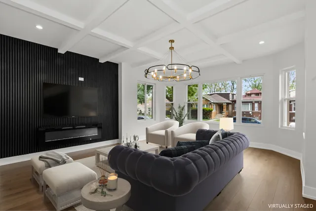 a living room with furniture kitchen and a chandelier