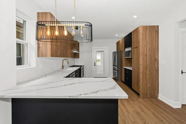 a kitchen with a sink stainless steel appliances and counter space
