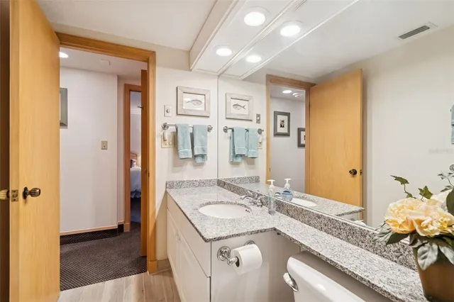 a en suite bathroom with a double vanity sink and a mirror