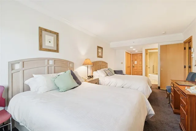 an aerial view of a house a yard and mountain view in back
