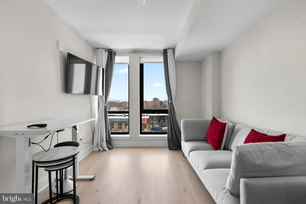 a view of a livingroom with furniture and a flat screen tv