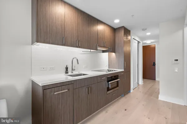 a kitchen with sink a refrigerator and cabinets