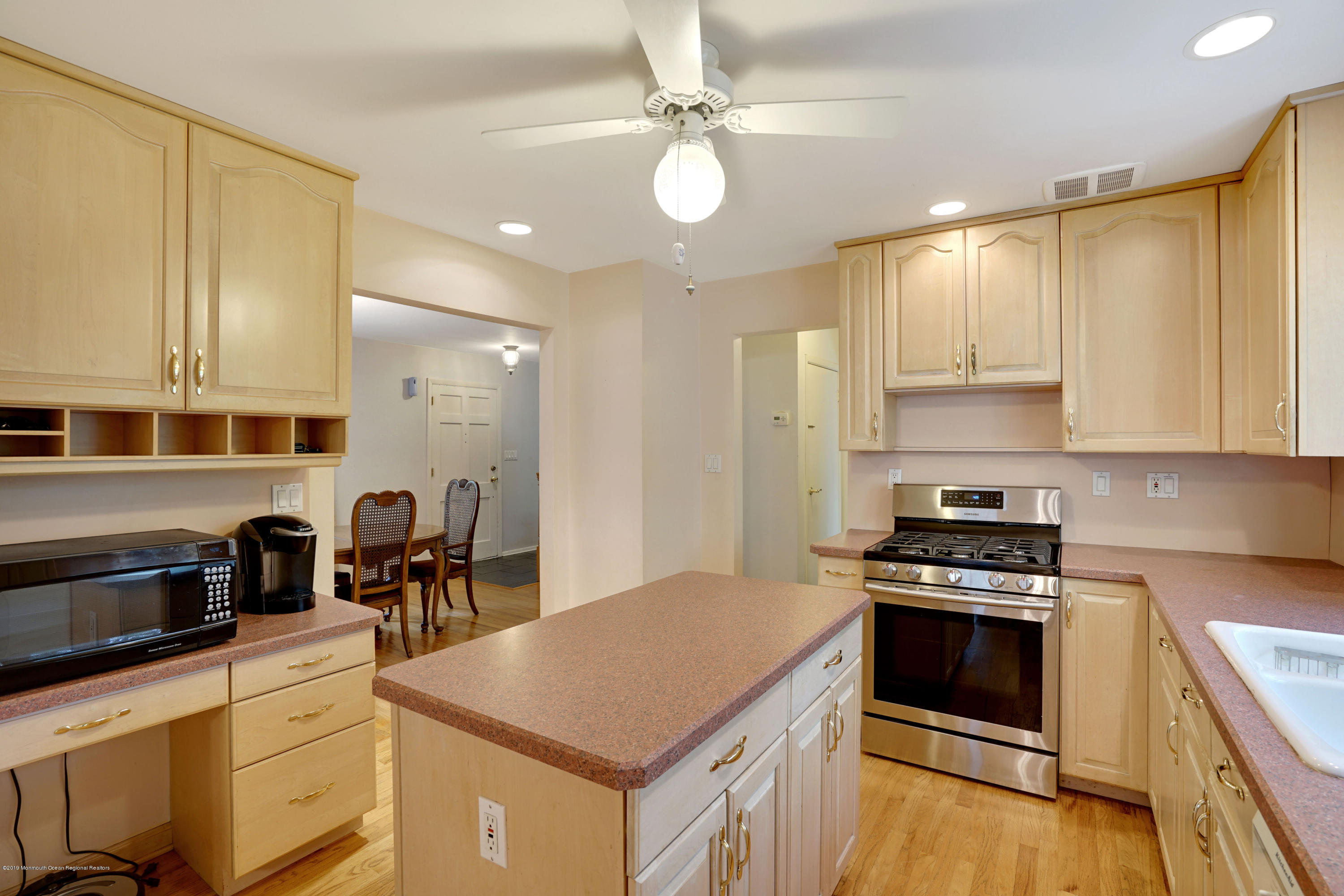 a kitchen with stainless steel appliances granite countertop a stove a sink and a refrigerator