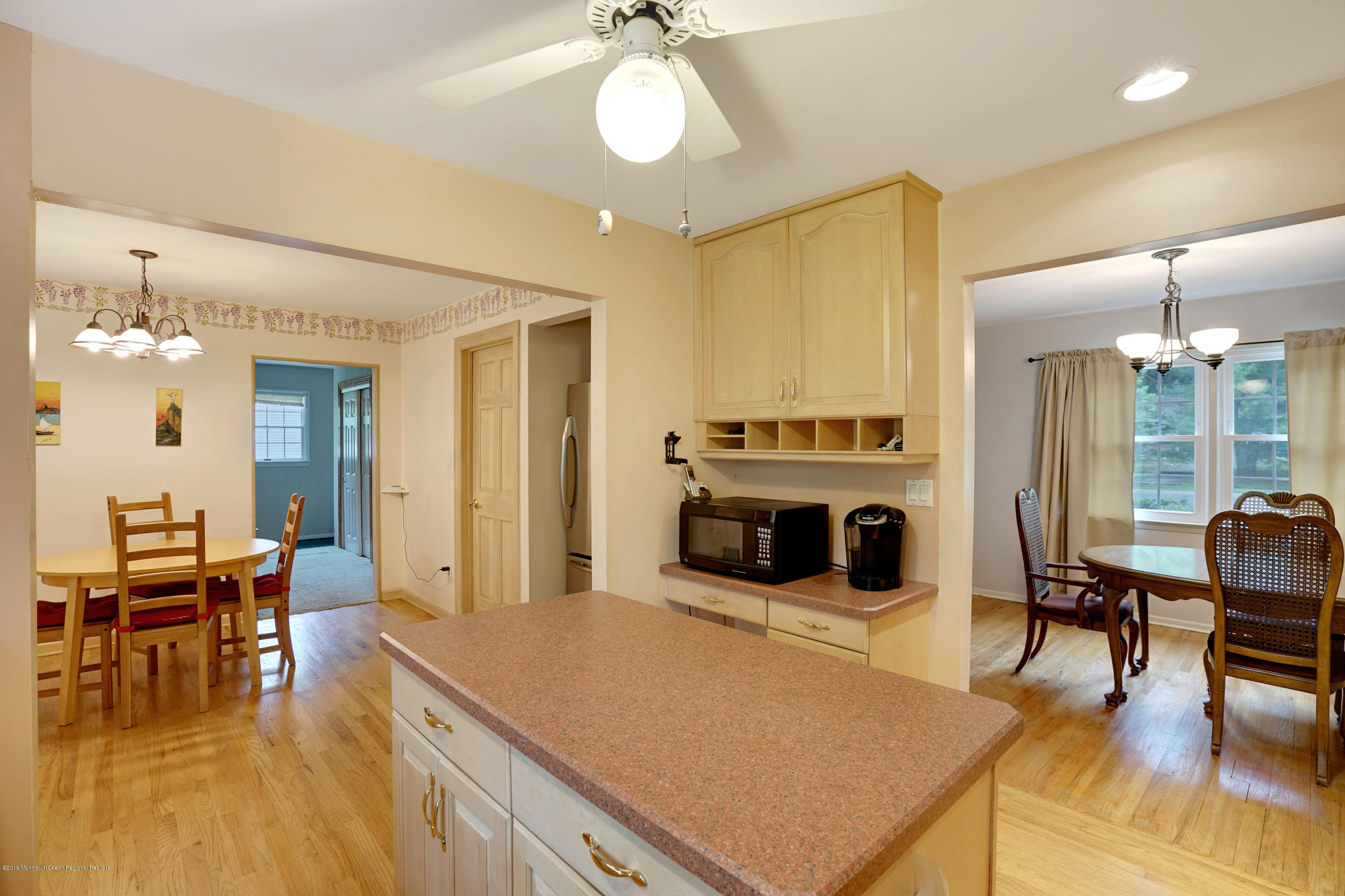 26 Marc Drive Matawan, NJ 07747 - Photo 30 of 30 a living room with furniture a fireplace and a dining table with wooden floor