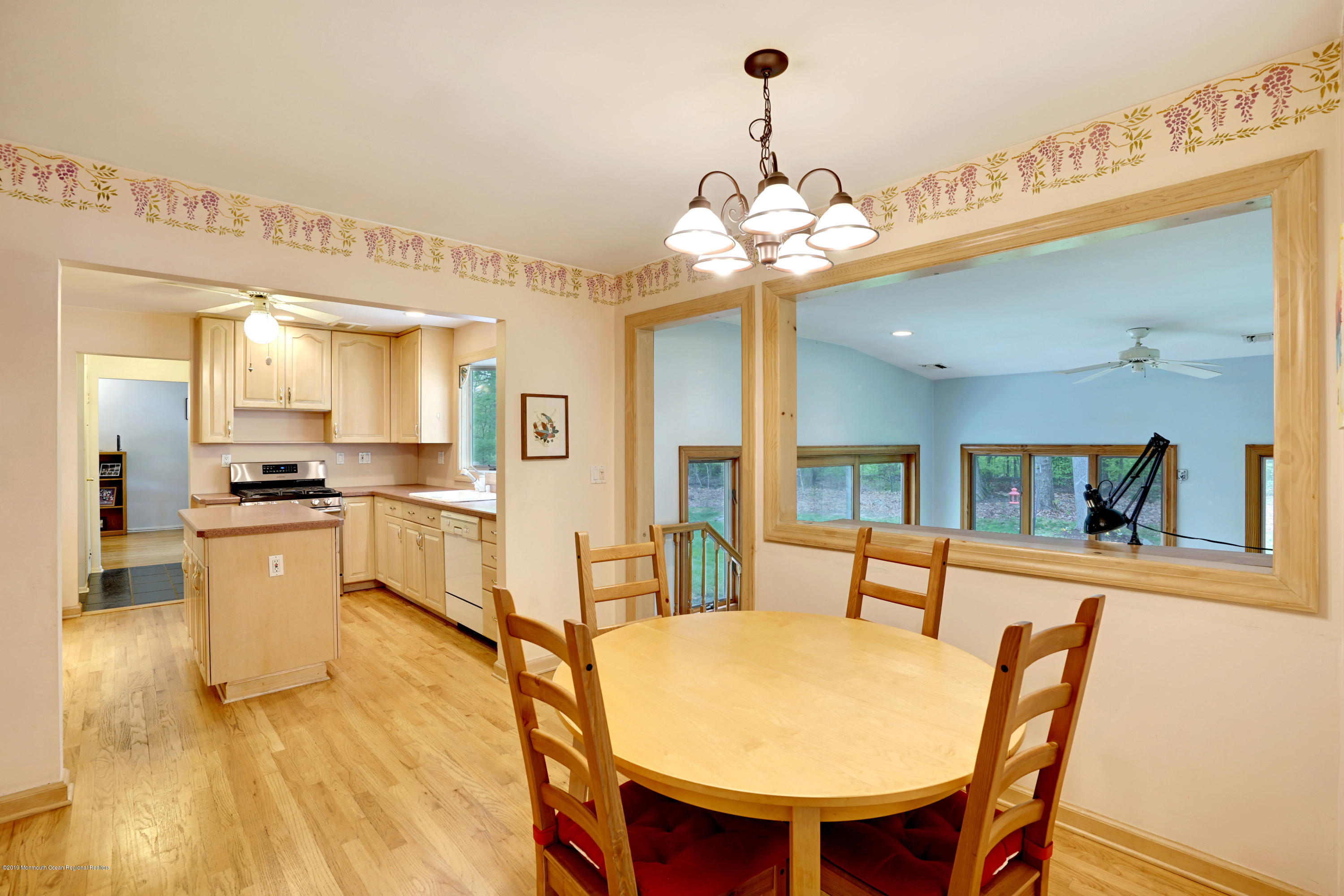 26 Marc Drive Matawan, NJ 07747 - Photo 11 of 30 a view of a dining room with furniture and a chandelier