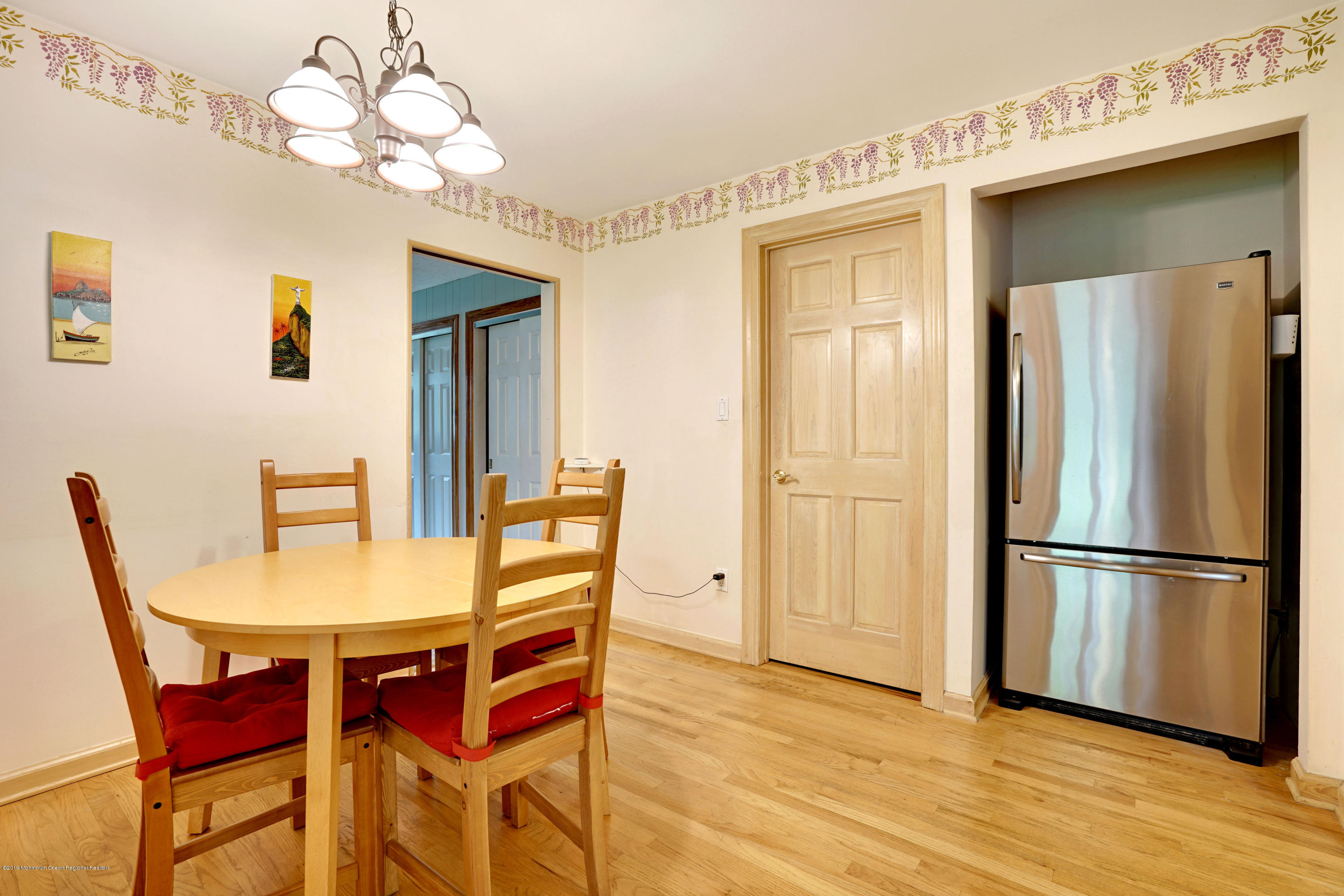 26 Marc Drive Matawan, NJ 07747 - Photo 12 of 30 a view of a dining room with furniture wooden floor and chandelier