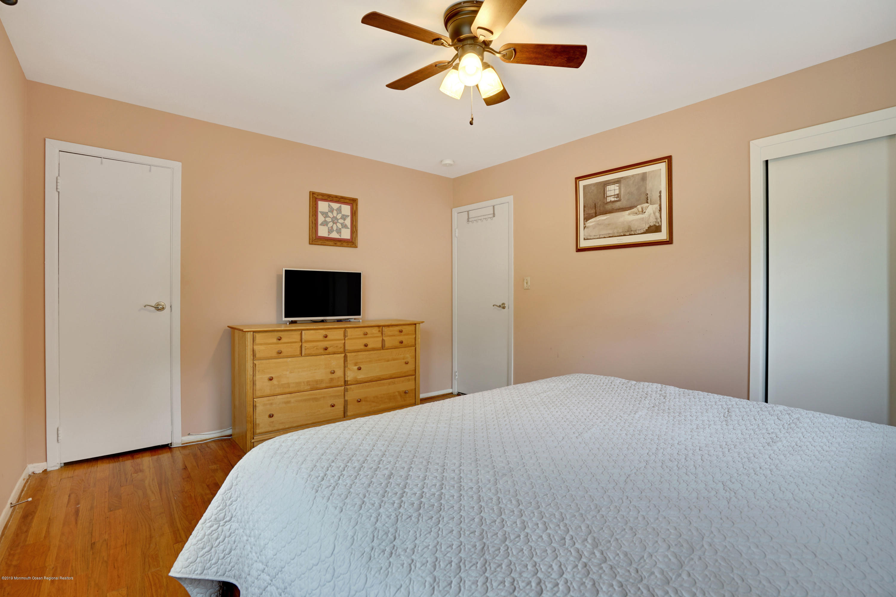 26 Marc Drive Matawan, NJ 07747 - Photo 19 of 30 a bedroom with a bed and a flat screen tv