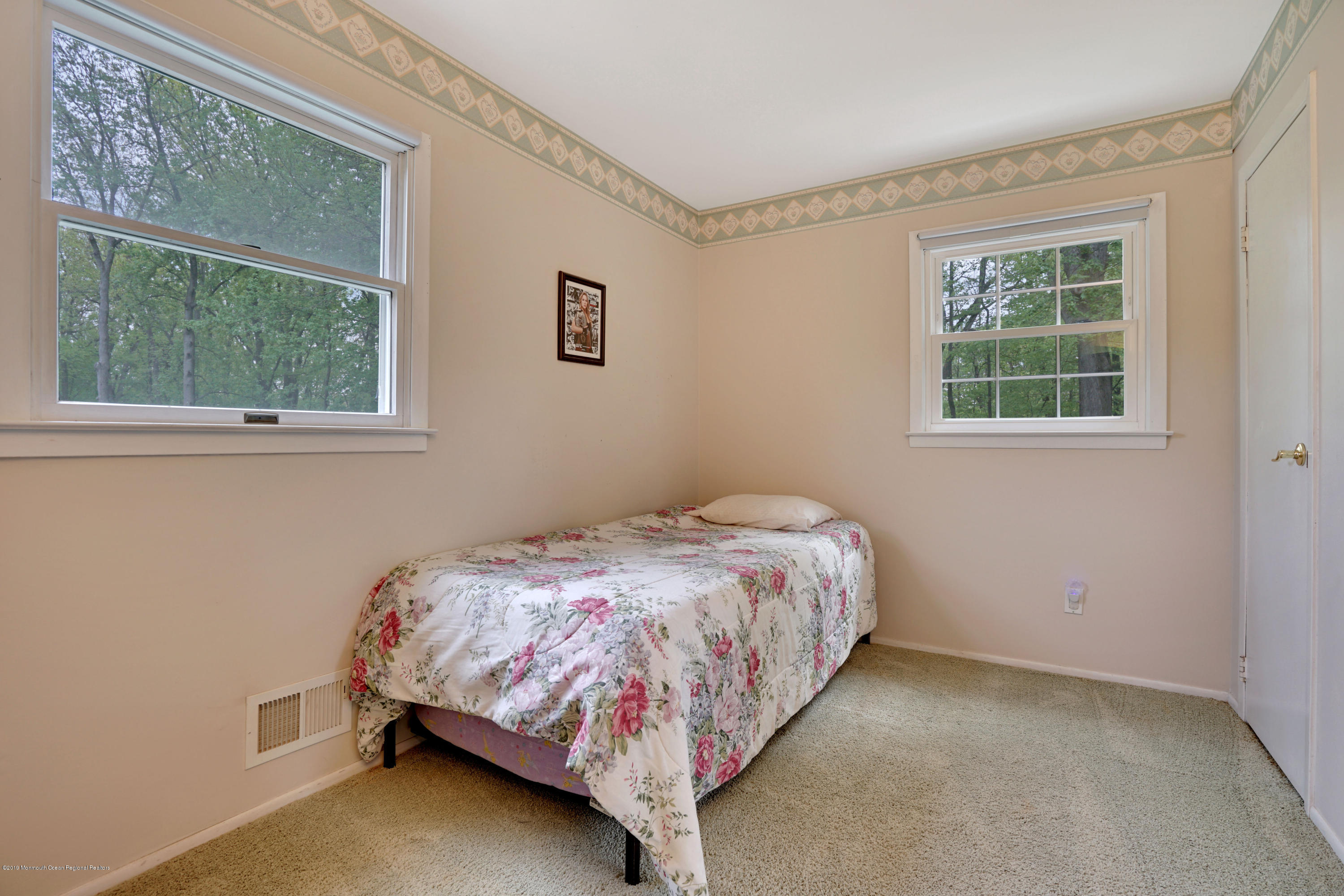 26 Marc Drive Matawan, NJ 07747 - Photo 21 of 30 a bedroom with a bed lamp and window