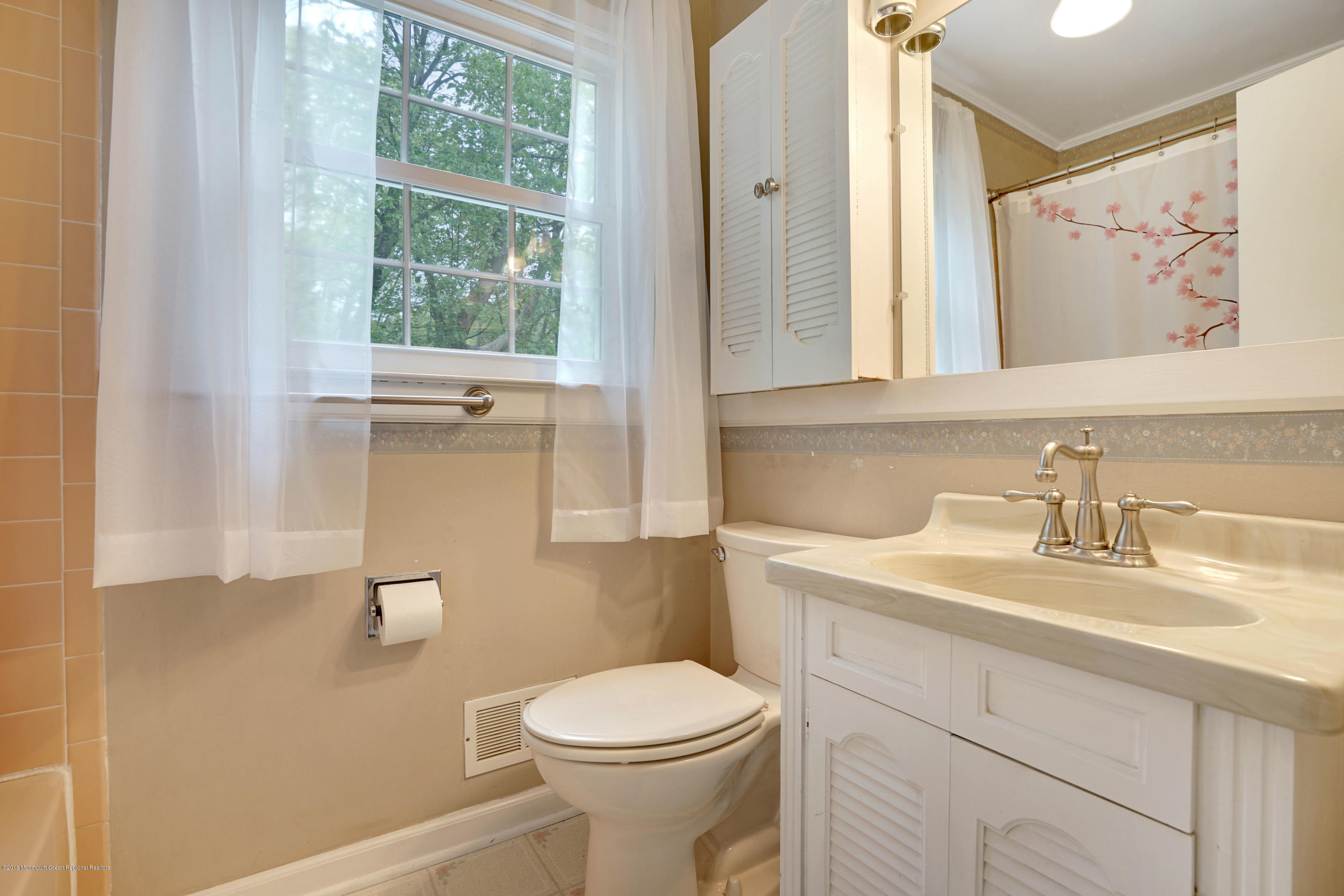 26 Marc Drive Matawan, NJ 07747 - Photo 23 of 30 a bathroom with a toilet a sink and a mirror