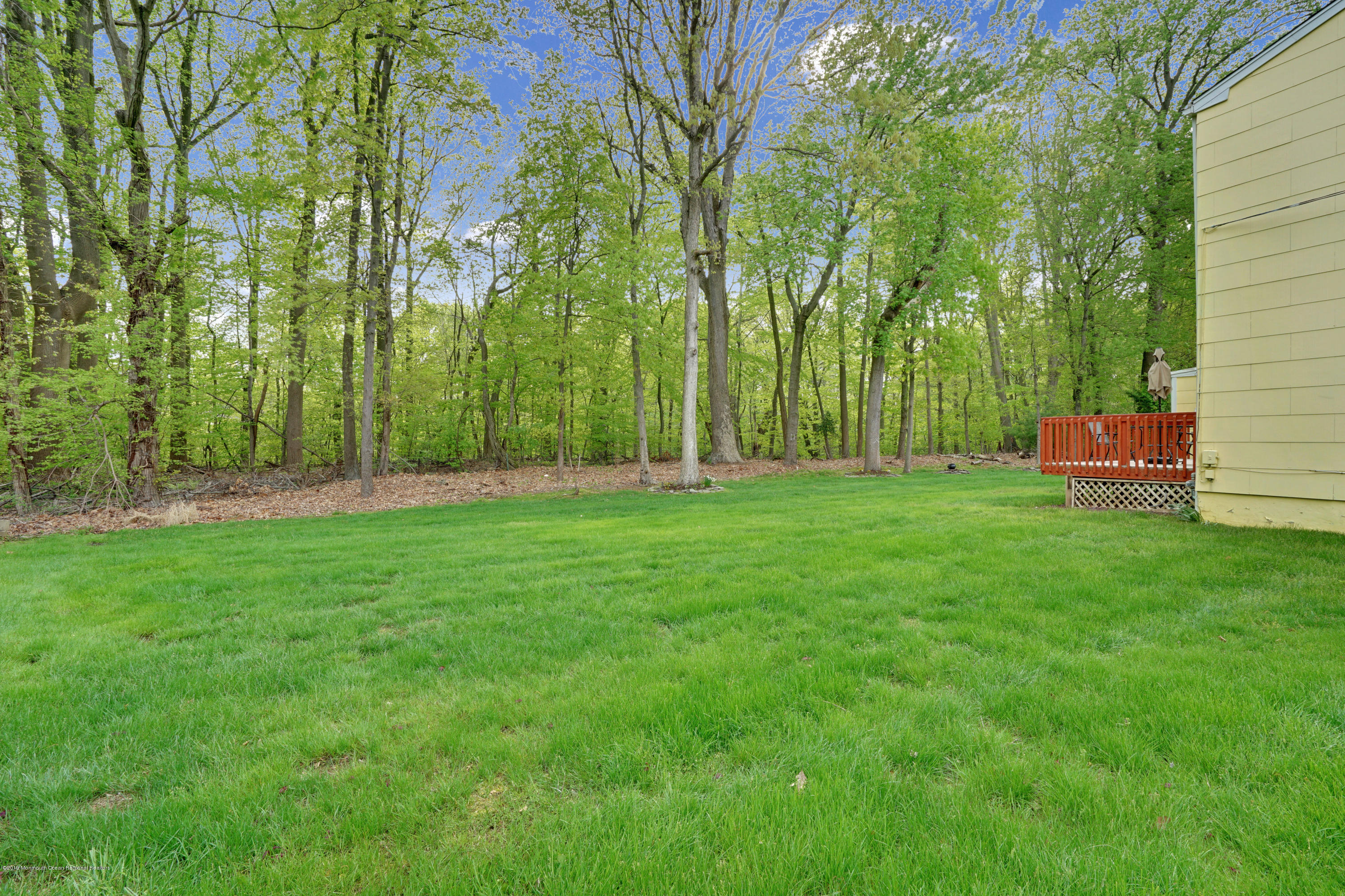 26 Marc Drive Matawan, NJ 07747 - Photo 26 of 30 a backyard of a house with lots of green space