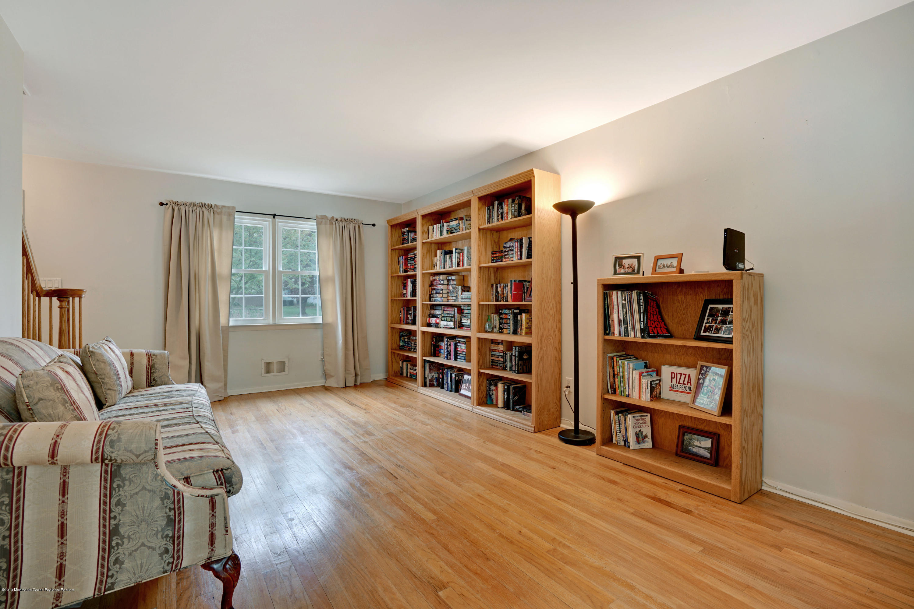 26 Marc Drive Matawan, NJ 07747 - Photo 4 of 30 a living room with furniture and a book shelf