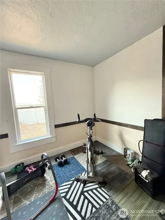 a bathroom with a granite countertop sink a mirror and shower