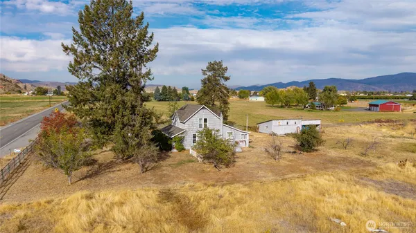 an aerial view of a house with a mountain