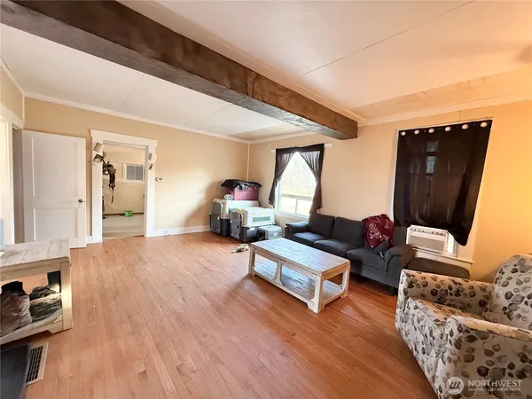 a bedroom with furniture and wooden floor