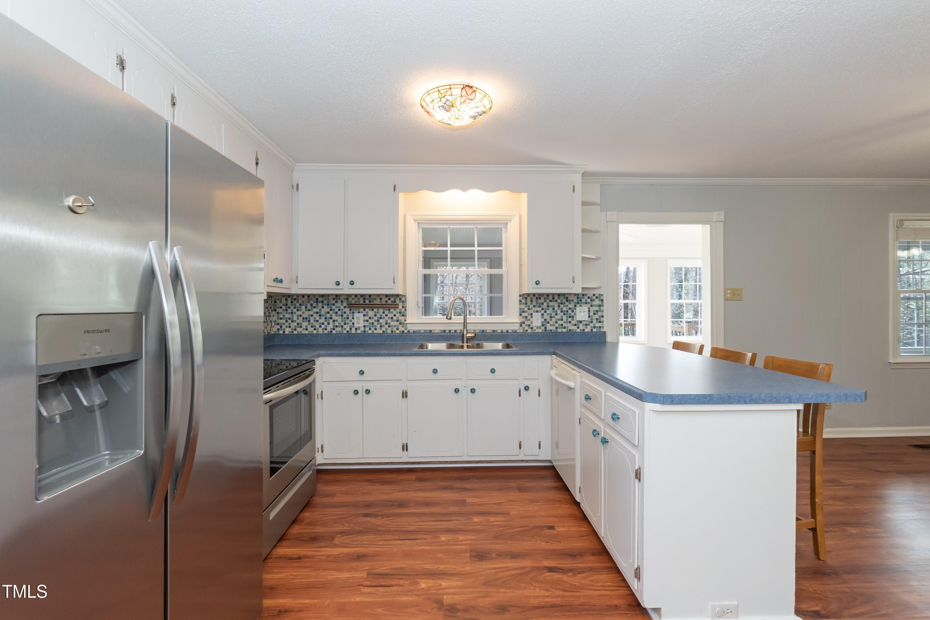 5604 Genesee Drive Durham, NC 27712 - Photo 13 of 45 a kitchen with stainless steel appliances granite countertop a sink and a refrigerator