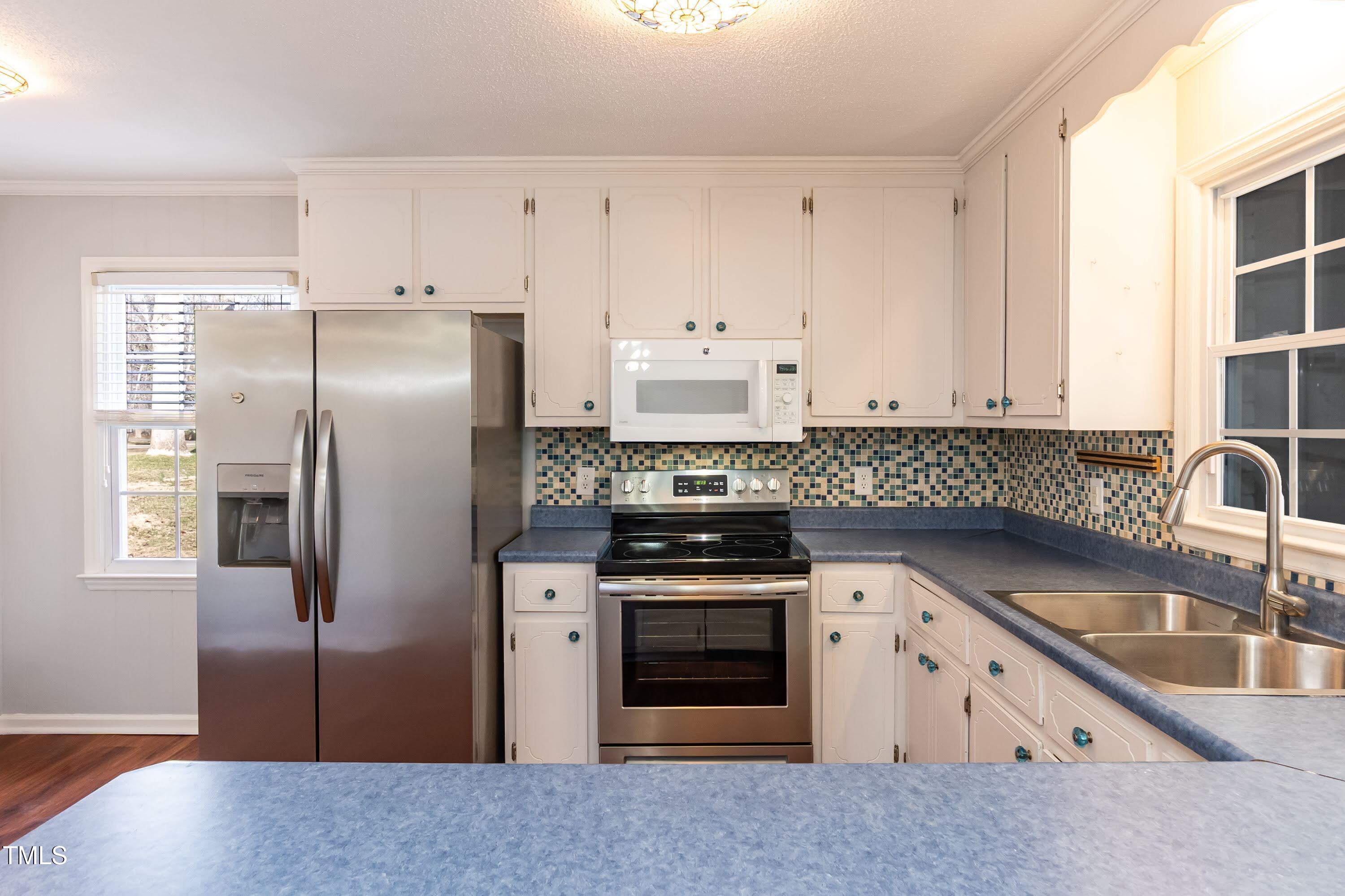 5604 Genesee Drive Durham, NC 27712 - Photo 16 of 45 a kitchen with stainless steel appliances granite countertop a refrigerator stove and sink